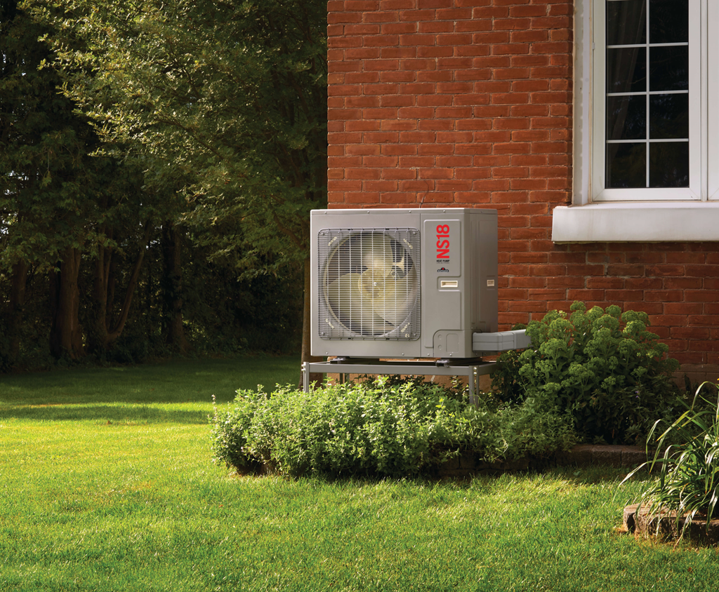 Napoleon NS18 heat pump condensing unit for a 2 ton central HVAC system. These units are whisper quiet, efficient, and all-electric. Designed to be floor mounted or wall-mounted, elevated above the ground as is shown here.